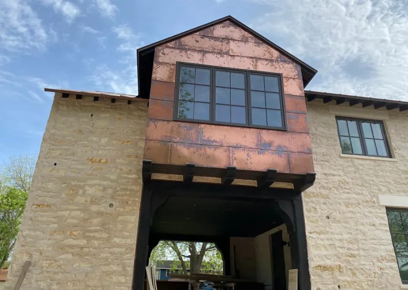 Copper metal panel facade on a stone building for Skylight Installation in Lynwood